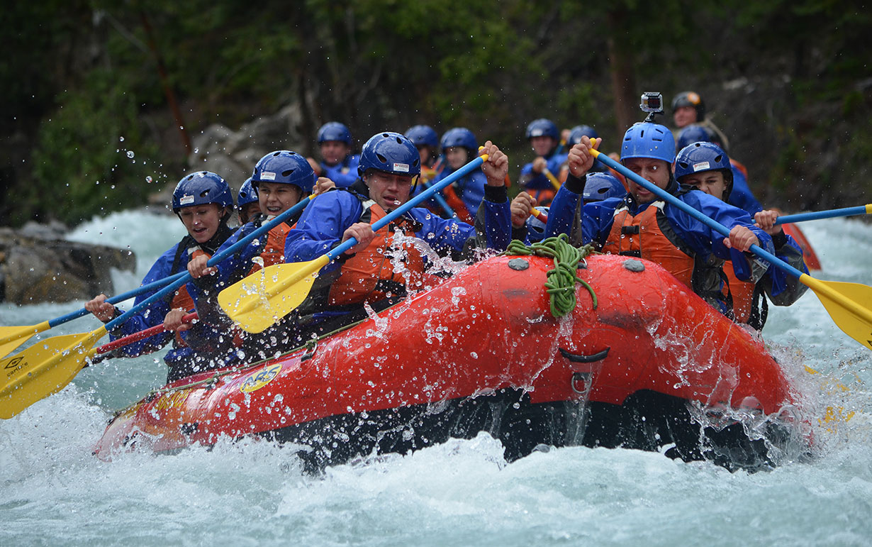 Tourists rafting through whitewaters in Canmore