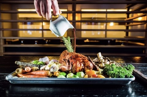 Roast Chicken Dinner platter with all the fixings or potatoes and carrots, with gravy slowing pouring over the top served at Table Food + Drink in Canmore, Alberta, their Tuesday dining special