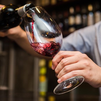 Red wine being poured into a glass at Fergus and Bix in Canmore, Alberta