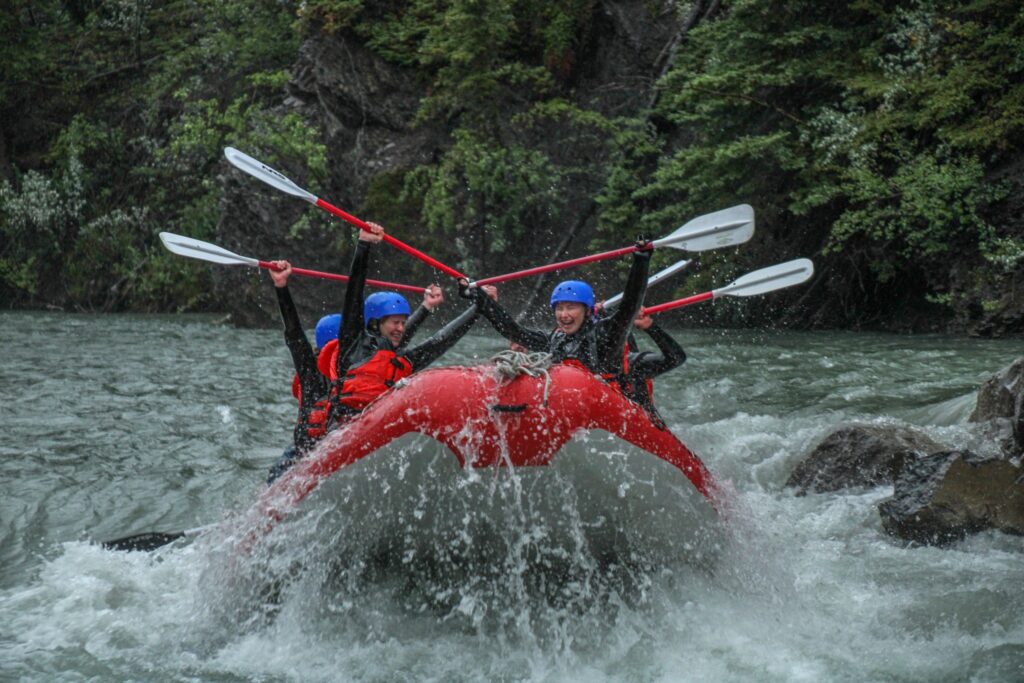 Rafters rafting a class 3 rapid with Canadian Rafting Rafting